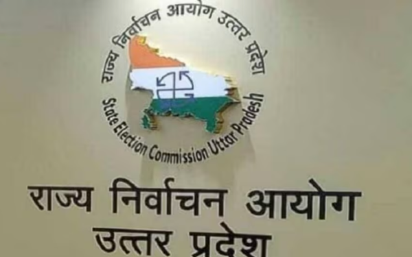 त्तर प्रदेश में मतदाता पंजीकरण कैंप के दौरान मतदाता सूची में नाम जांचने में सहायता करते बीएलओ